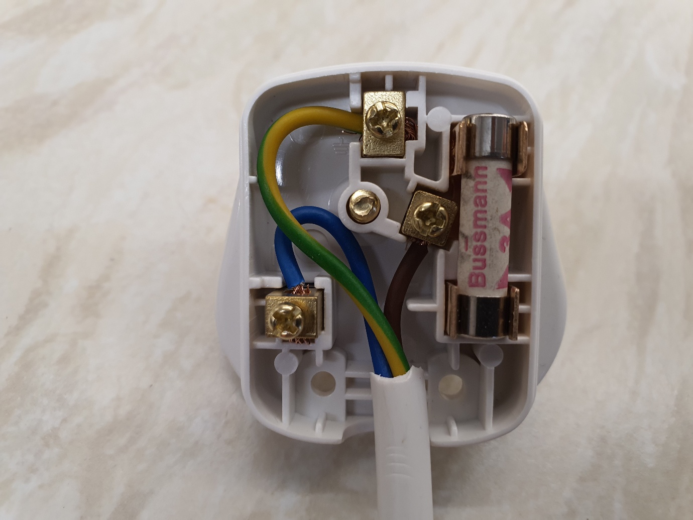 A white electrical outlet with wires

AI-generated content may be incorrect.